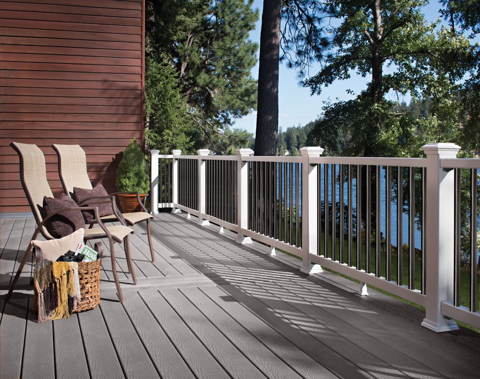 Lakefront deck with chairs and railing