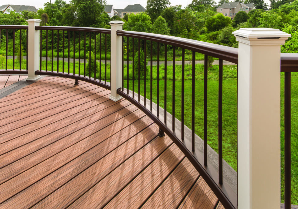 Curved wooden deck with dark metal railing